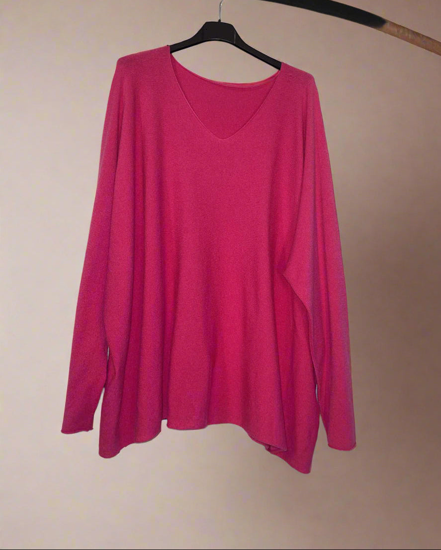 Pink long-sleeve shirt on a hanger against a white background