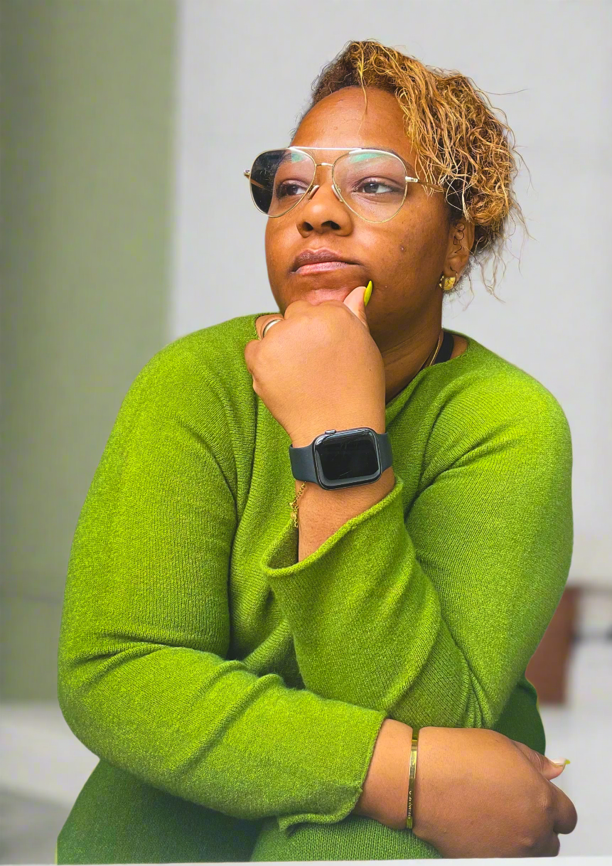 Person wearing a green sweater and black smartwatch,思考着